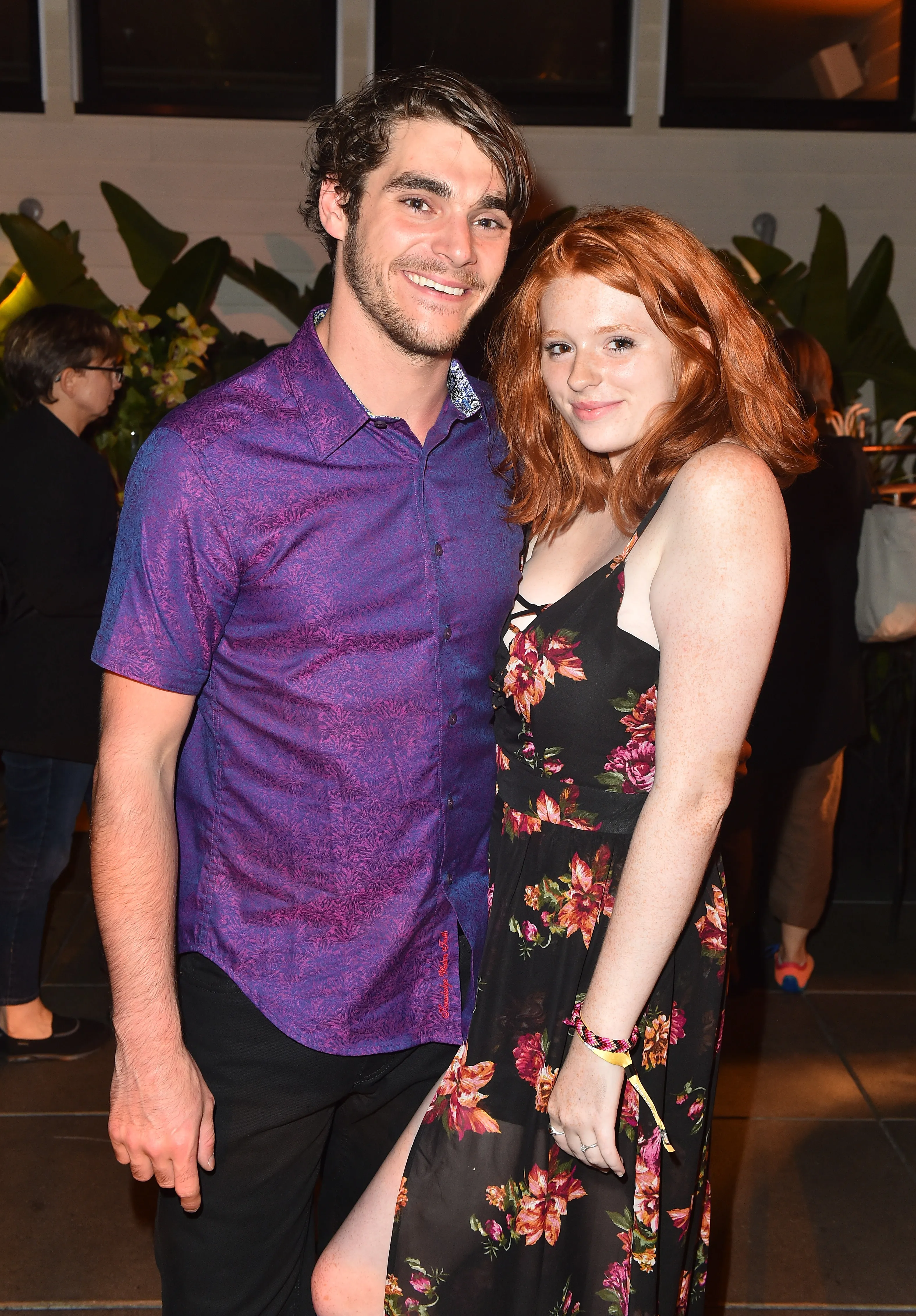 RJ Mitte and Lacianne Carriere stand together smiling at an event.