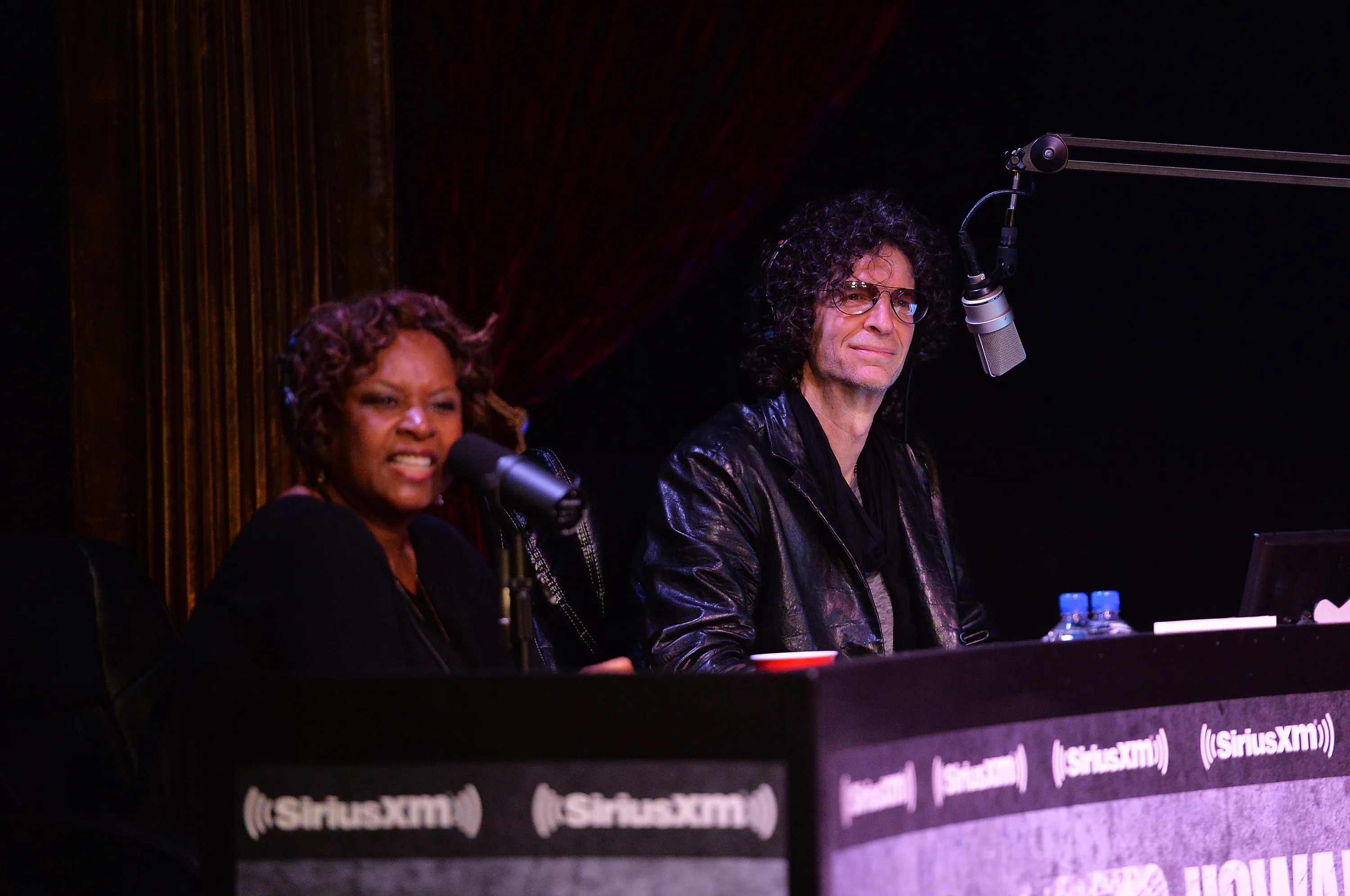 Robin Quivers and Howard Stern speaking at a SiriusXM Town Hall.