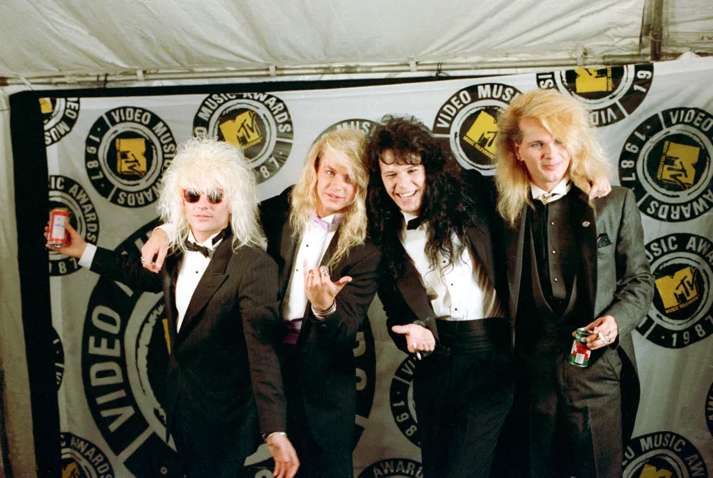 Rock band Poison, from left, C.C. Deville, Bret Michaels, Bobby Dall and Rikki Rockett pose at the MTV Video Music Awards.