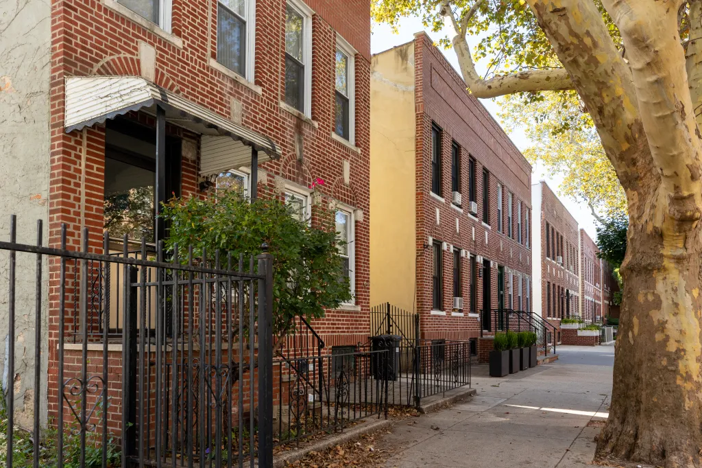 A row of brick homes along 44th Street in Astoria, Queens.