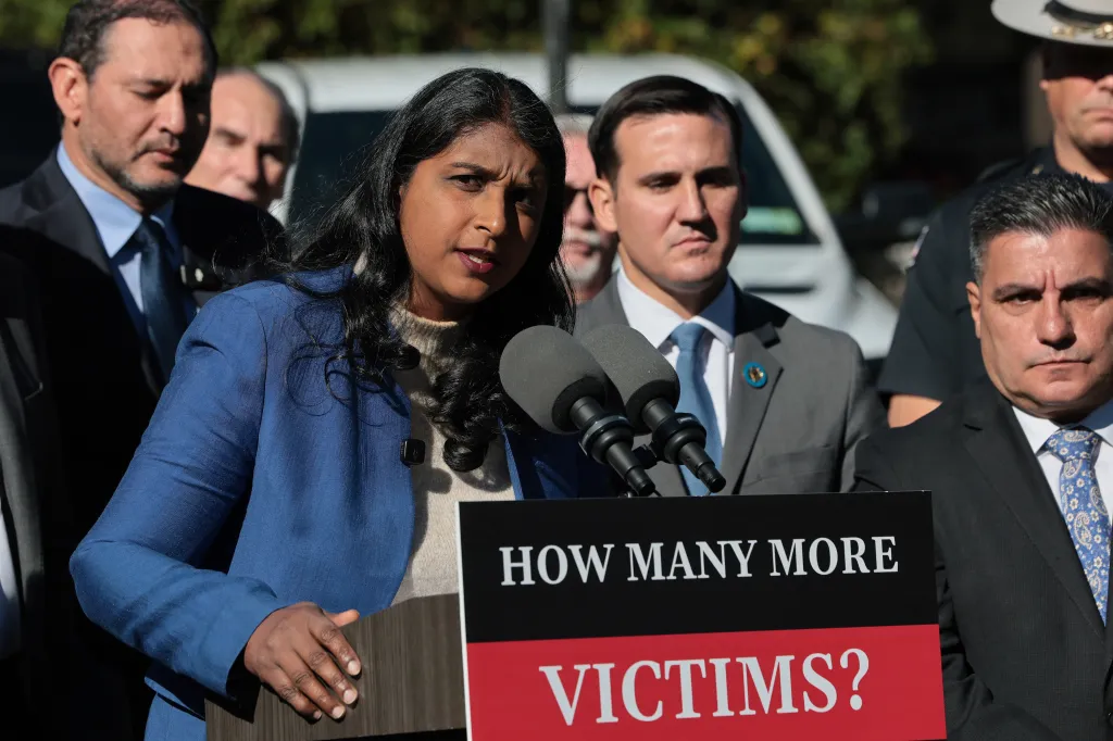 Republican attorney general candidate Saritha Komatireddy speaks at a press conference behind a podium that reads, 