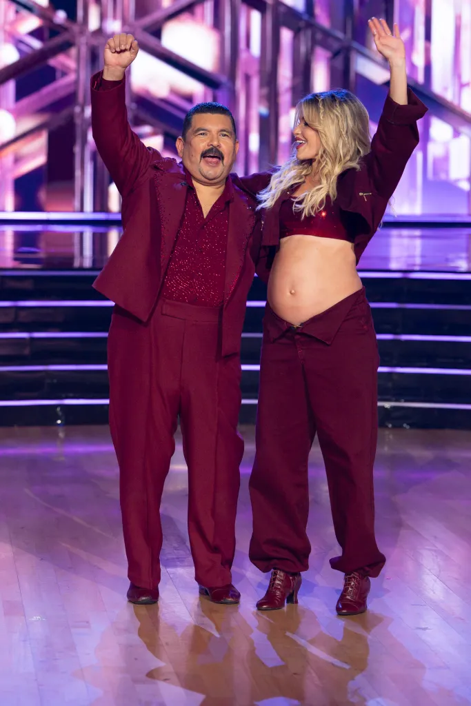 Guillermo Rodriguez and Witney Carson pose on the ballroom floor during 