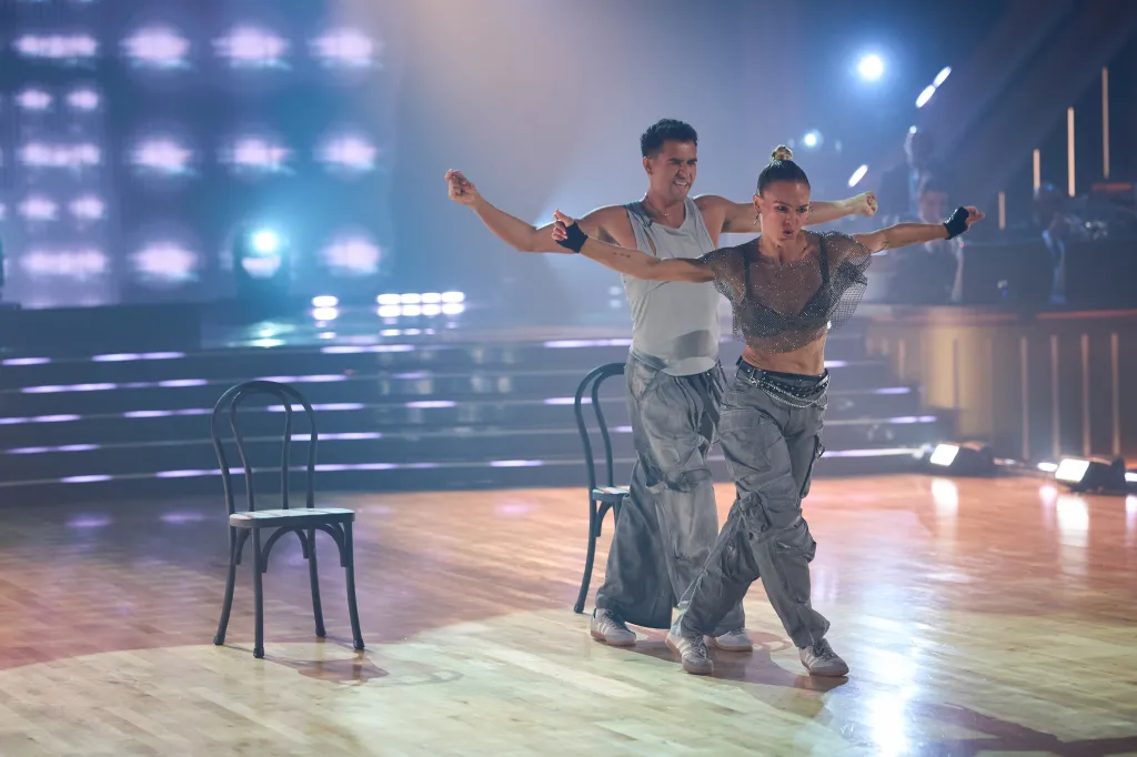 Ezra Sosa and Julia Stiles dance on the stage of Dancing with the Stars.