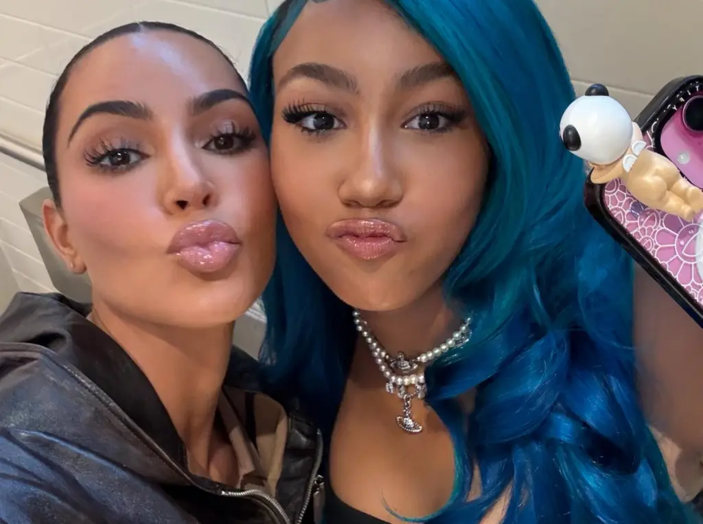 Kim Kardashian and North West pose for a selfie, both puckering their lips.