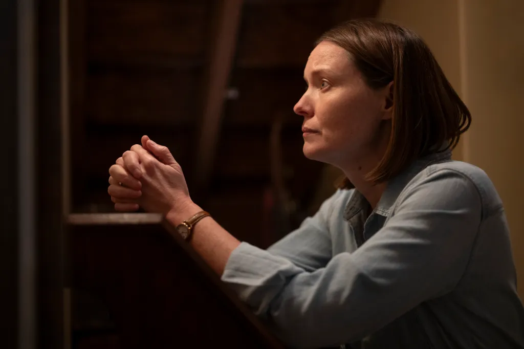 Samantha Sloyan with hands clasped in prayer.