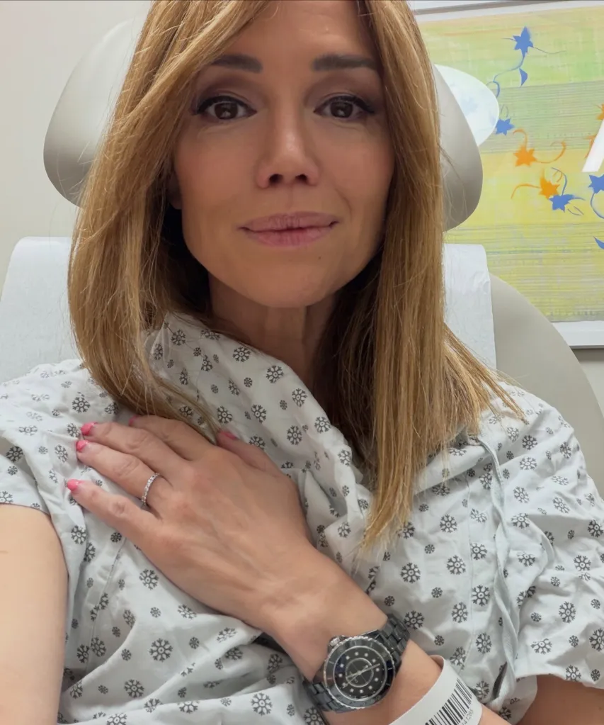 Sara Gore seated in a medical office wearing a gown.