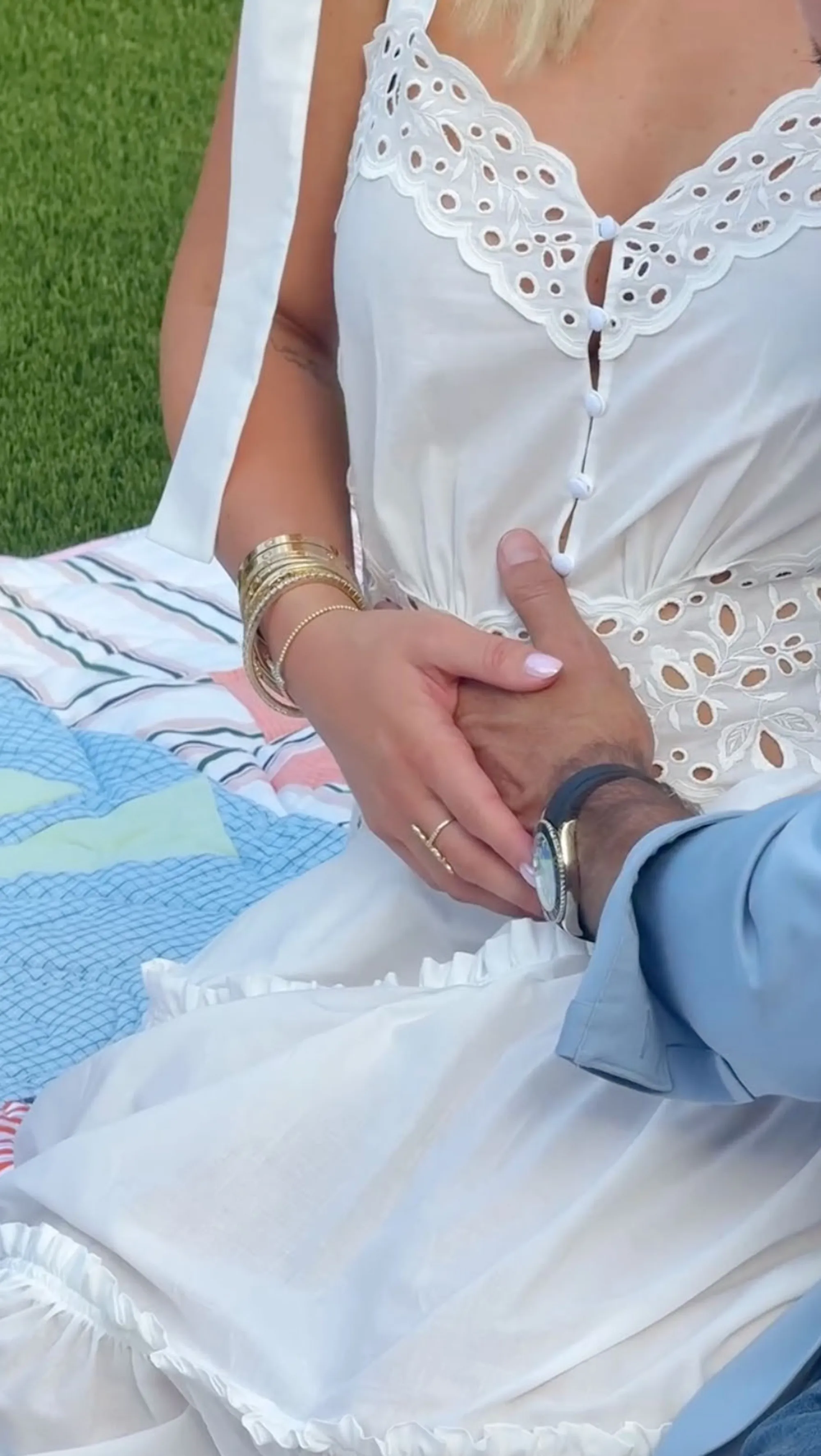 Savannah Chrisley wearing a white dress while holding hands with a man.