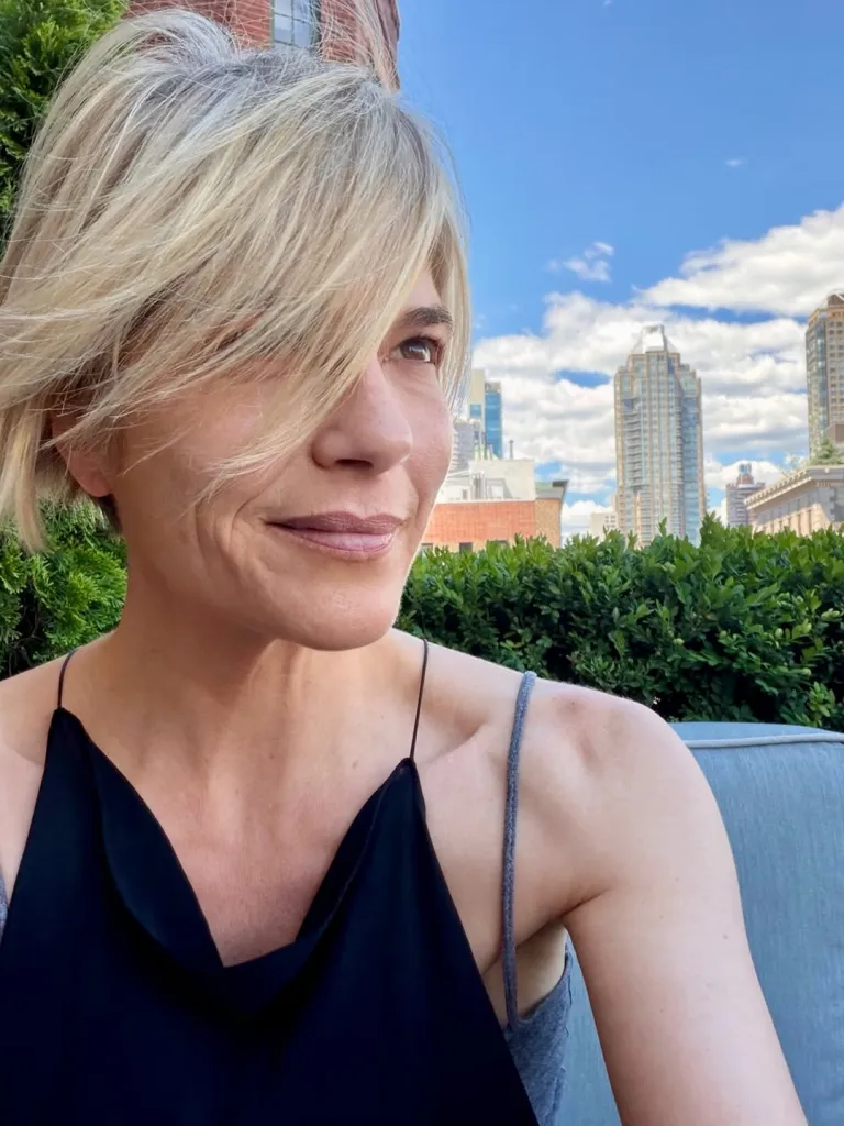 Selma Blair outdoors on a rooftop with a city skyline in the background.