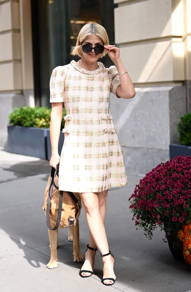 Selma Blair wearing a tweed dress and sunglasses while walking her dog in New York City.