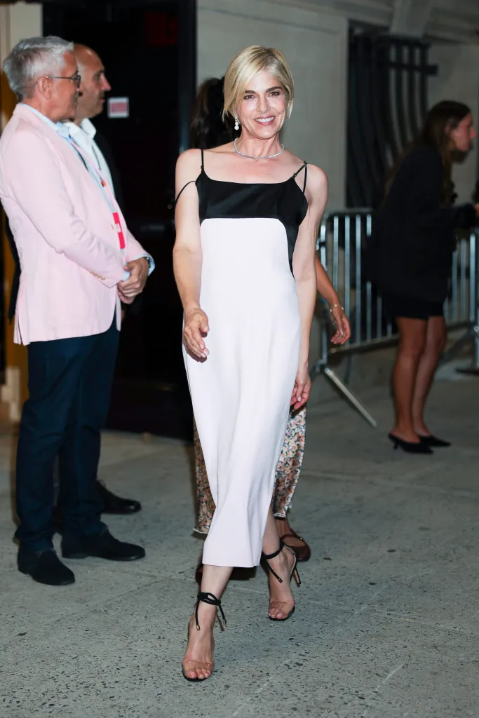 Selma Blair wearing a black and white slip dress with a diamond necklace.