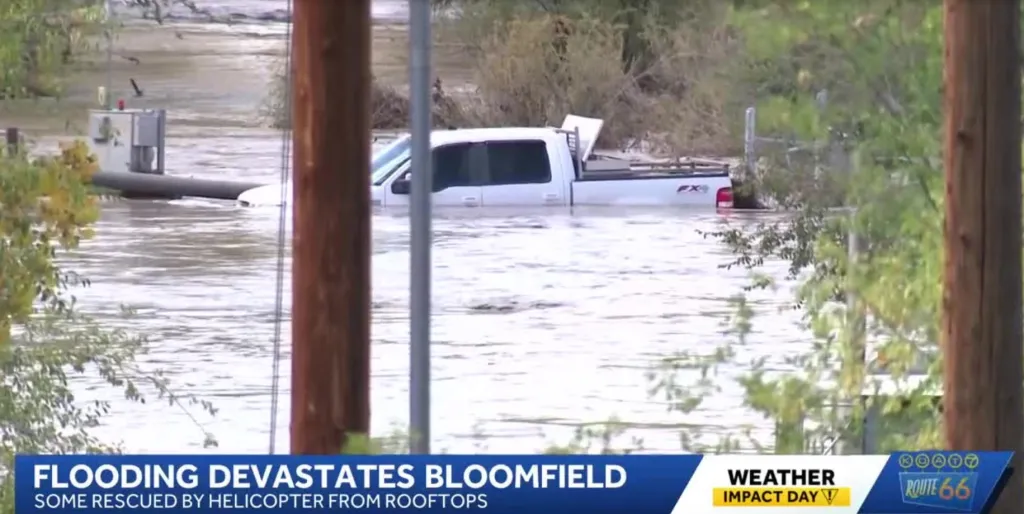 A white pickup truck submerged in floodwaters in northern New Mexico.