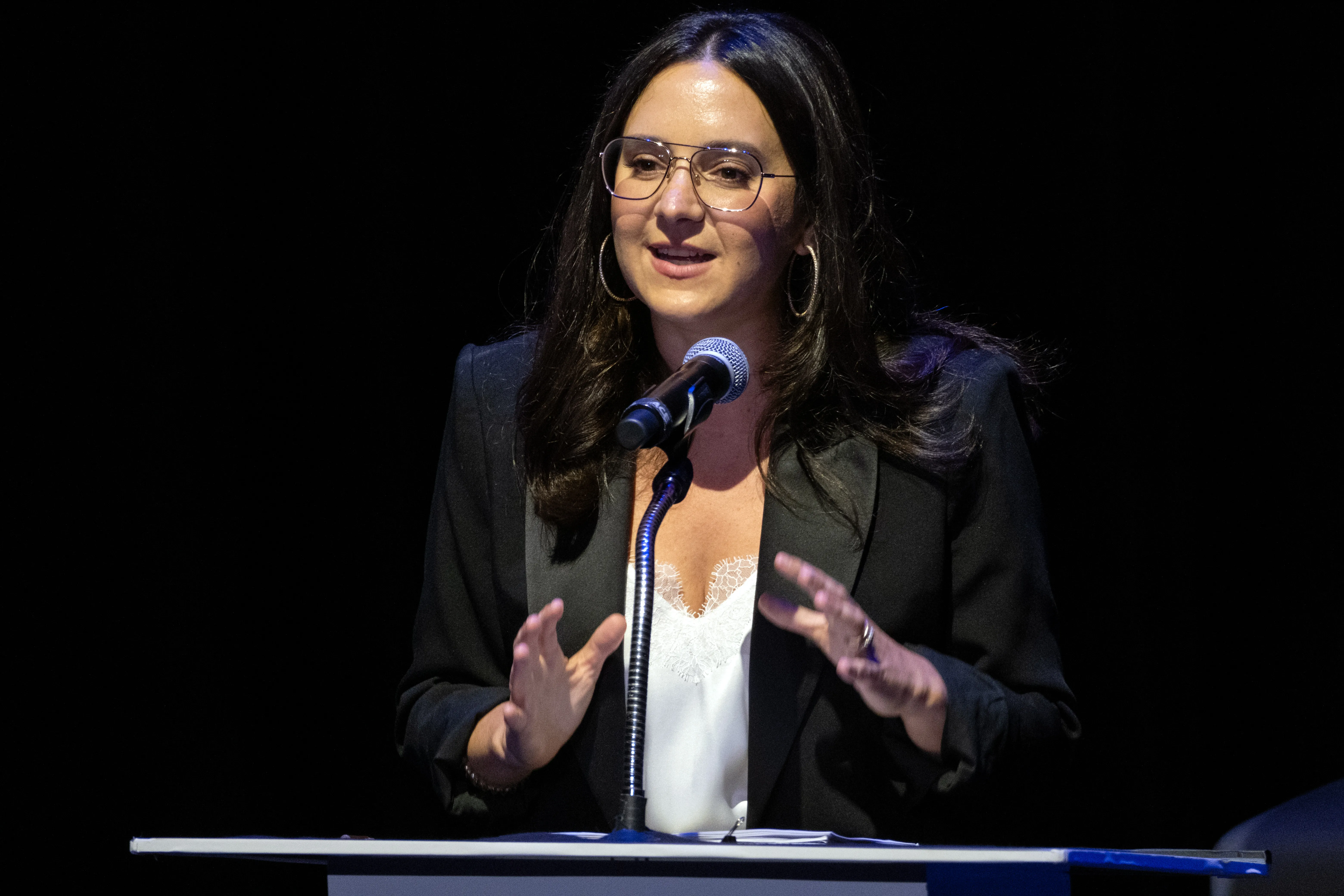 Bari Weiss speaks at a podium in Los Angeles.