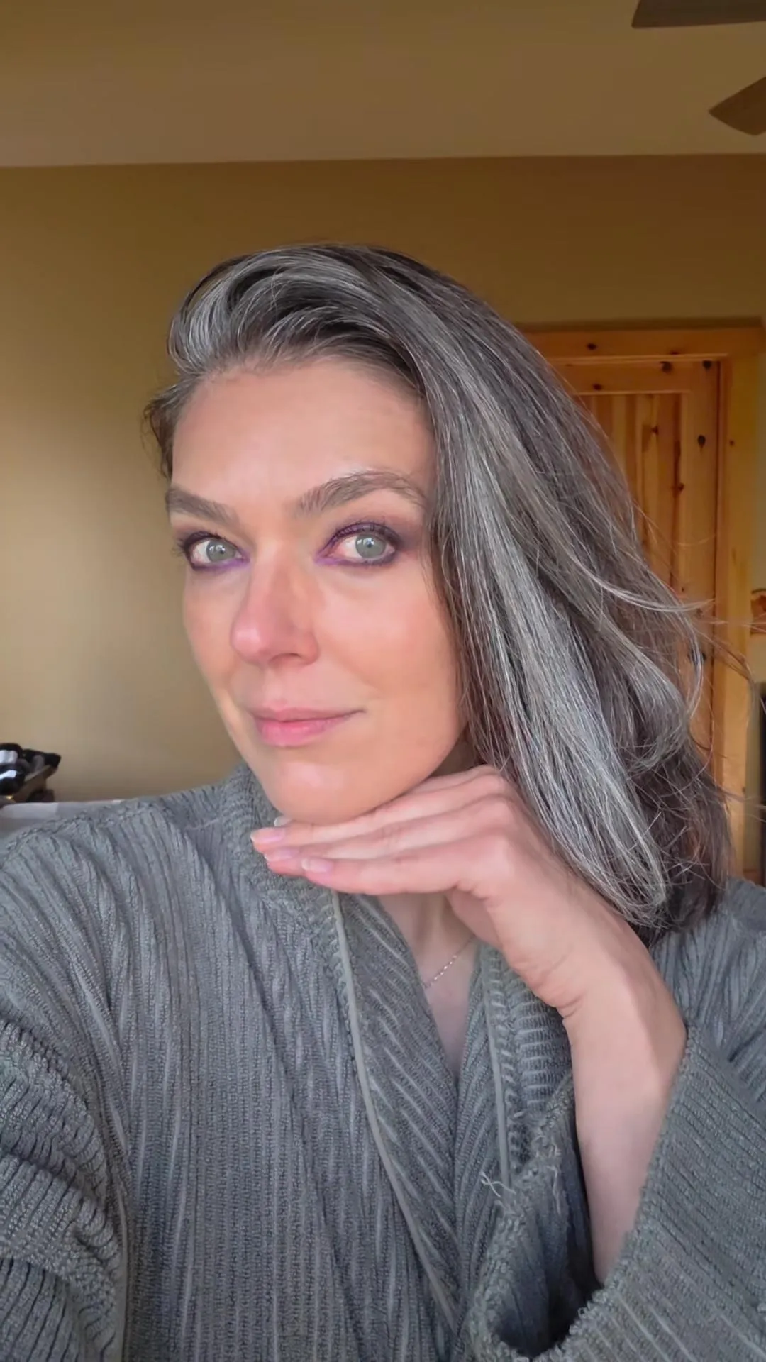 Adrianne Curry-Rhode posing for a selfie with her chin resting on her hand.