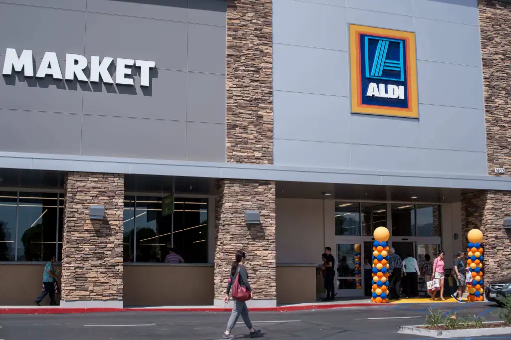 Shoppers walk into an Aldi supermarket during its grand opening.