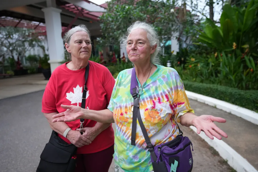 Carol Larson, 69, stands for an interview with her sister, Crystal Lavering, at the Independence Hotel in Sihanoukville, Cambodia.