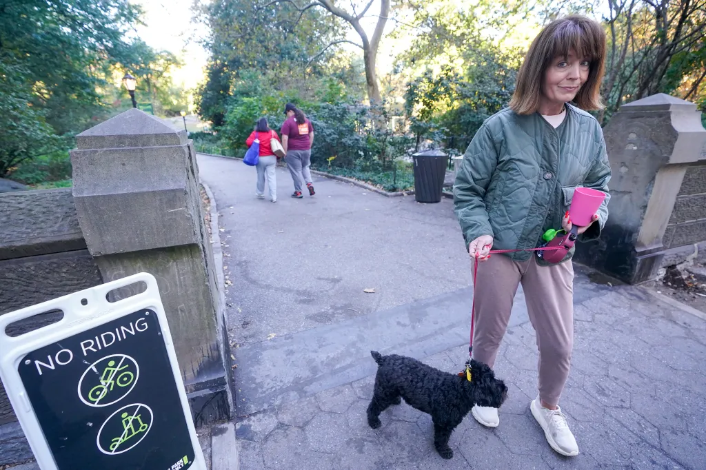 Anna Brockway stands in Central Park with her dog, near a path where a sexual assault was recently reported.