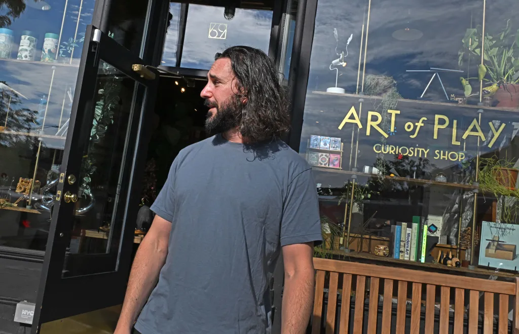 Adam Rubin, the owner of the Art of Play store, standing outside his shop in Brooklyn Heights.