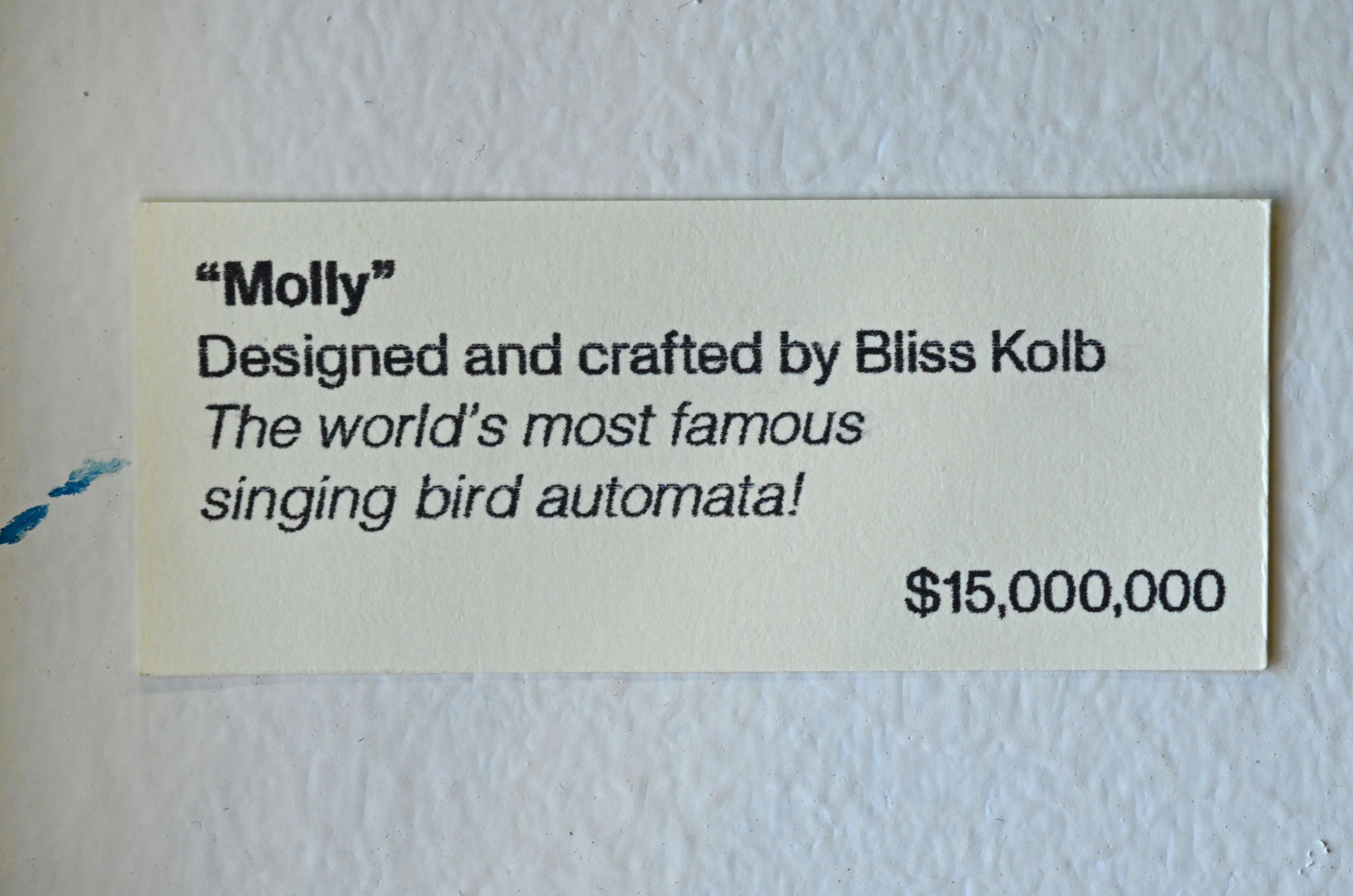 A museum-style label for the singing bird automaton titled 