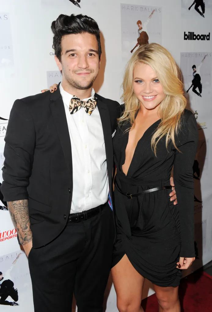 Singer Mark Ballas and dancer Witney Carson pose together on the red carpet.