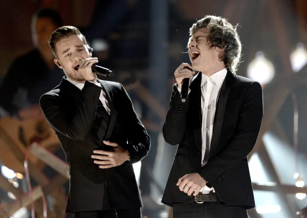 Singers Liam Payne and Harry Styles of One Direction perform onstage during an awards show.
