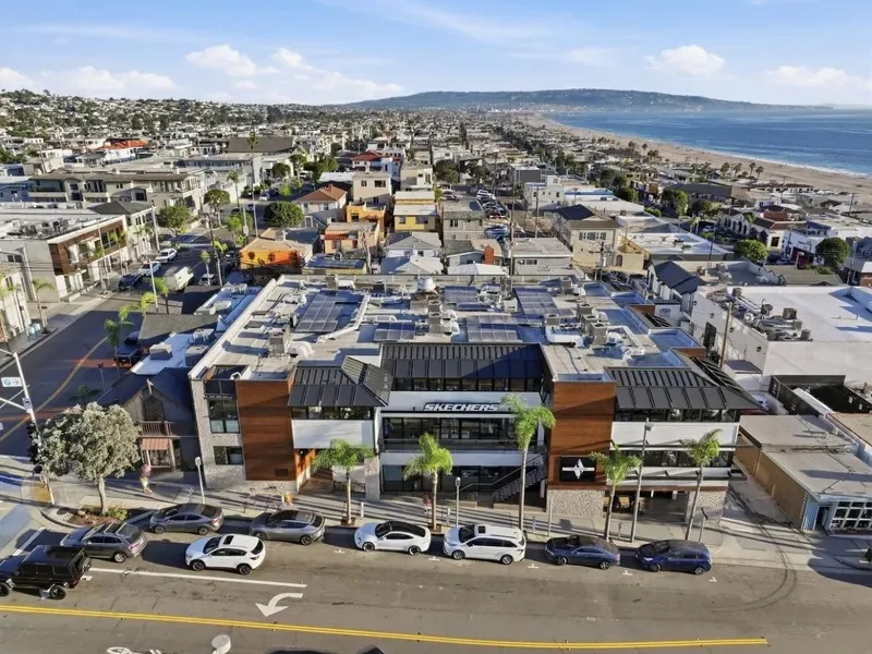Aerial view of the Skechers corporate headquarters in Manhattan Beach with the ocean and coastline in the background.