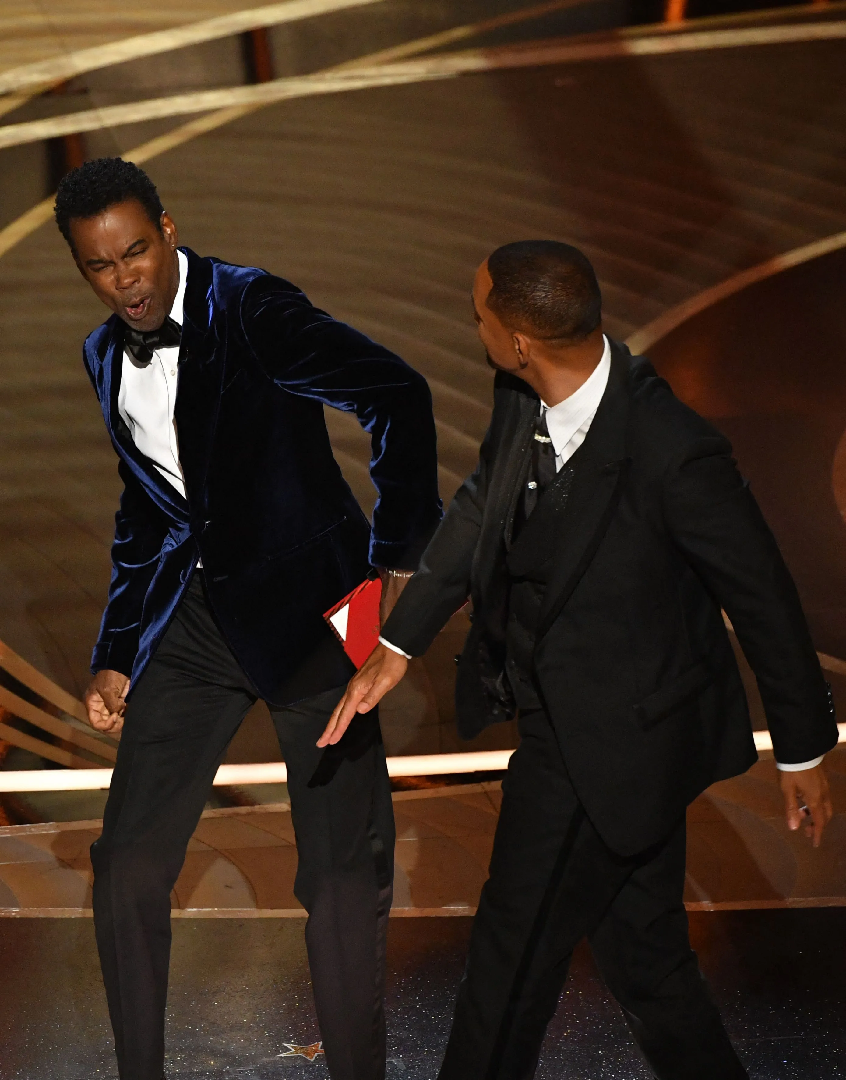 Will Smith slaps Chris Rock onstage at the Oscars.
