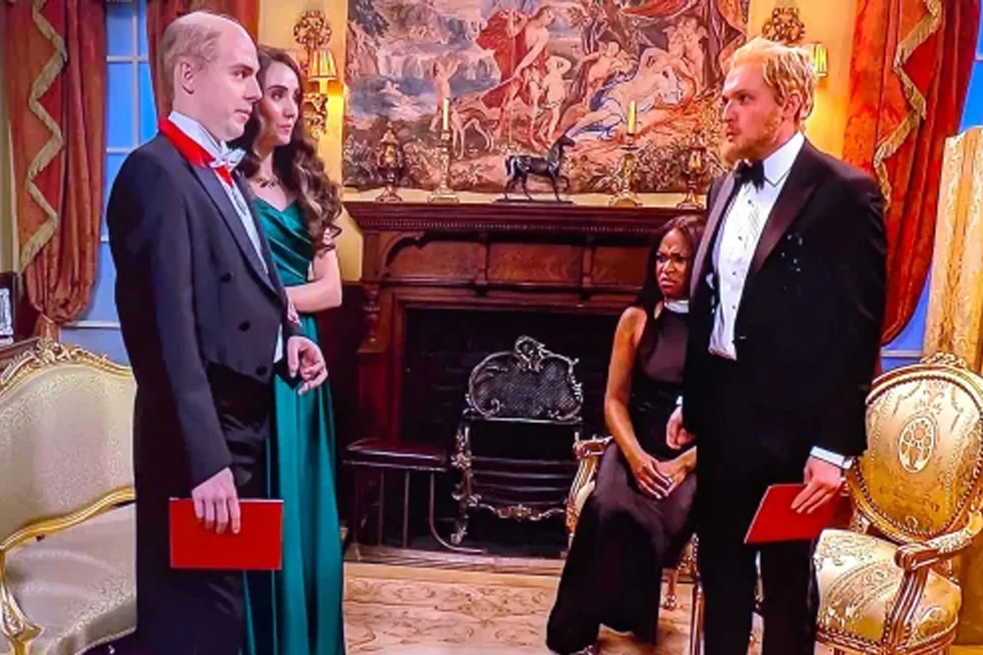 Four actors dressed in formal wear on a television set.