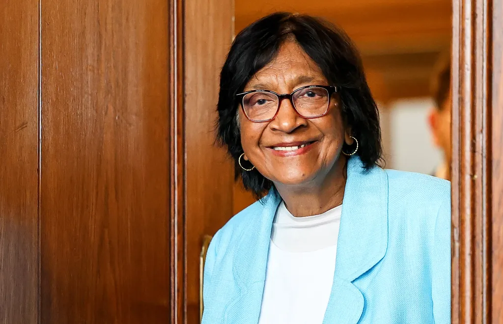 South African lawyer and human rights defender Navi Pillay smiling while wearing glasses and a light blue blazer.
