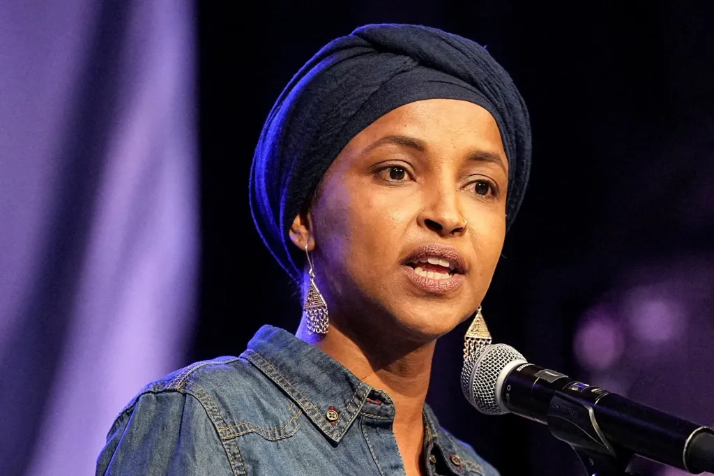 U.S. Representative Ilhan Omar speaks into a microphone during a campaign rally.