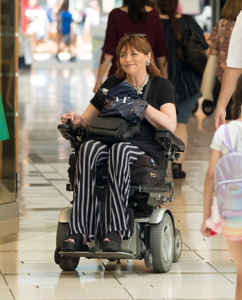 Samantha Markle in a wheelchair, smiling while shopping.