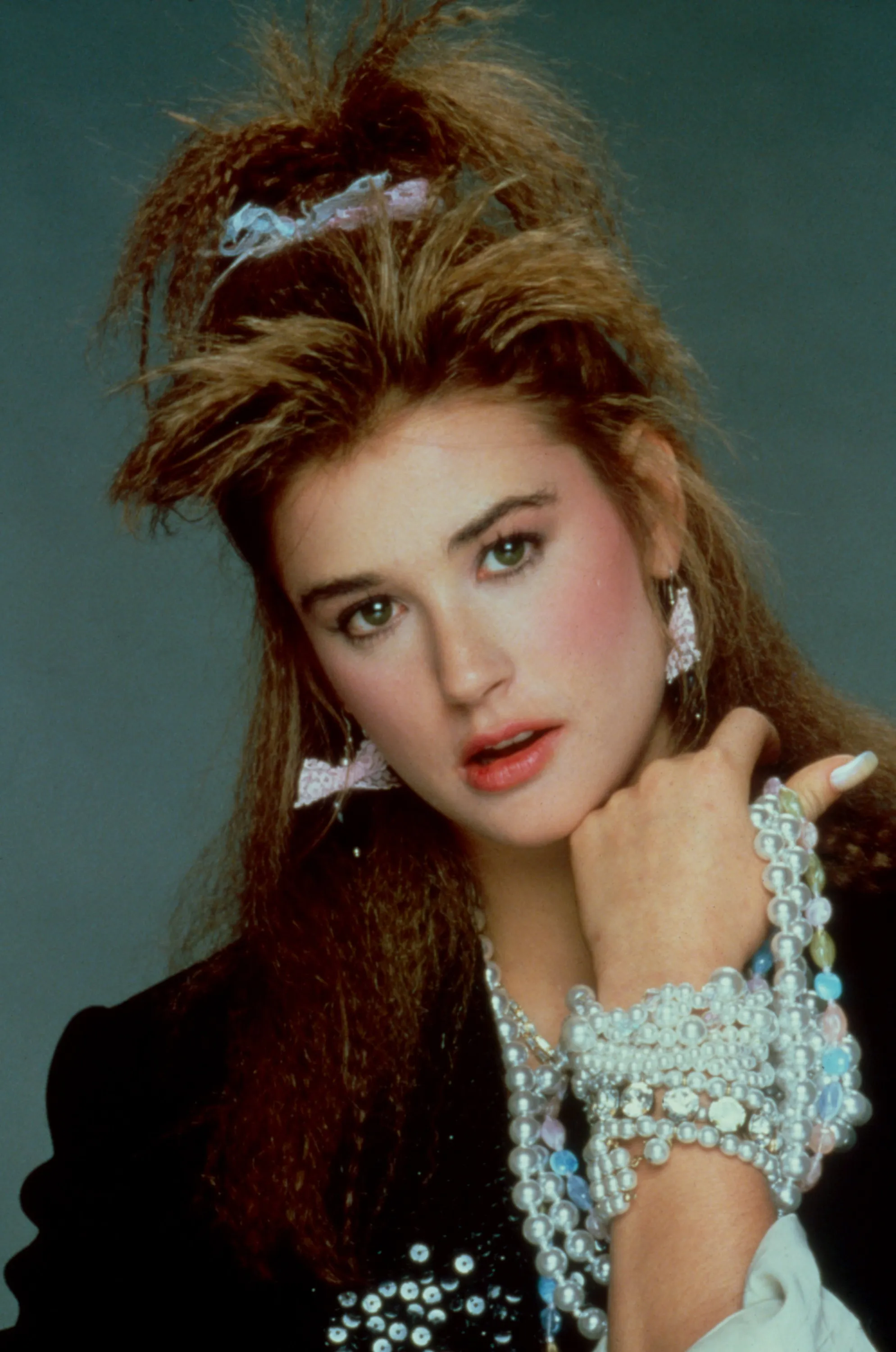 Demi Moore as Jules in St. Elmo's Fire, wearing pearls and a high ponytail.
