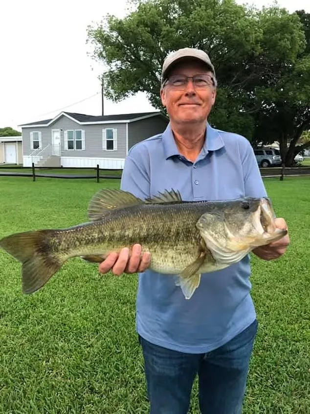 Steven Hamilton, 71, holding up his catch on the banks of Lake Apopka.