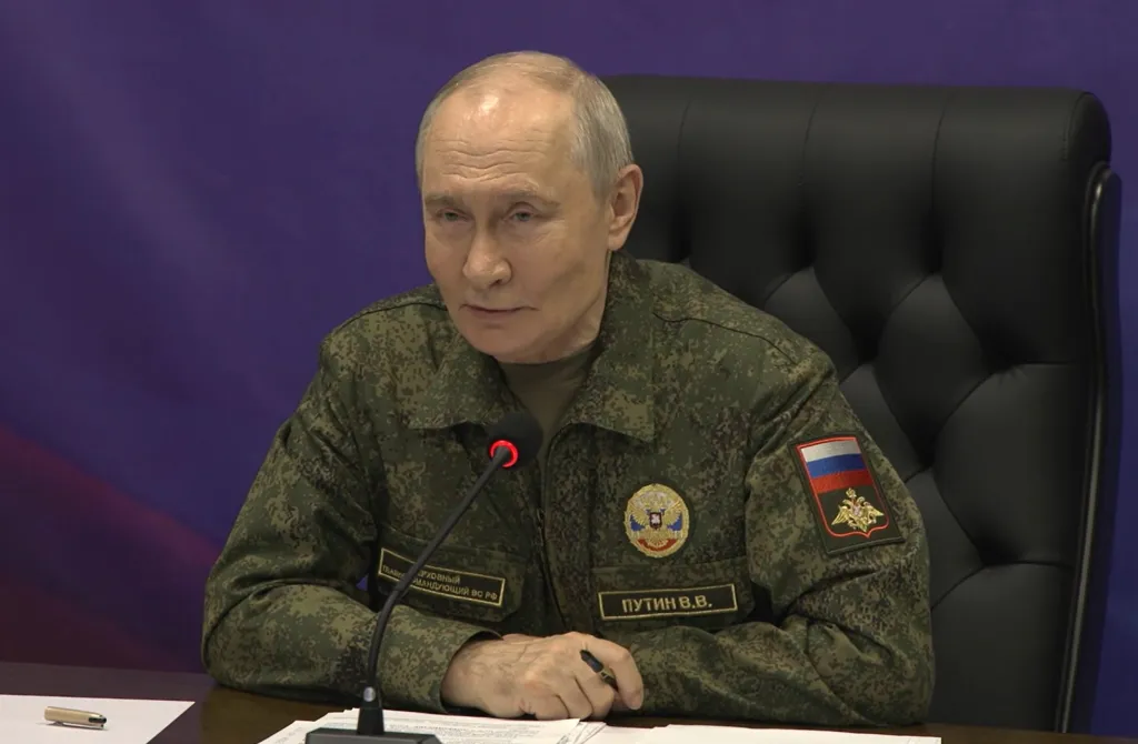 Russian President Vladimir Putin wearing a camouflage uniform at an auxiliary command post of the Joint Group of the Russian Forces.