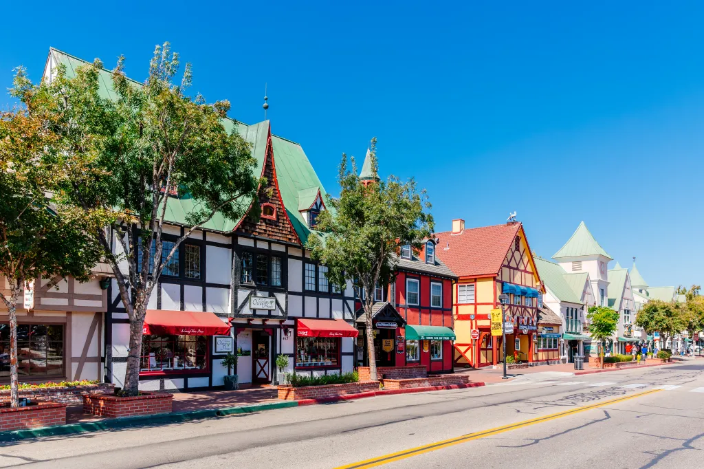 Colorful Danish-style buildings line a sunny street in Solvang, California.