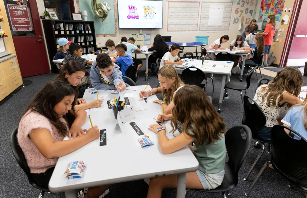 Students work at desks on the first day of school in Hannah Jones' 5/6 combo class at Trabuco Mesa Elementary School.