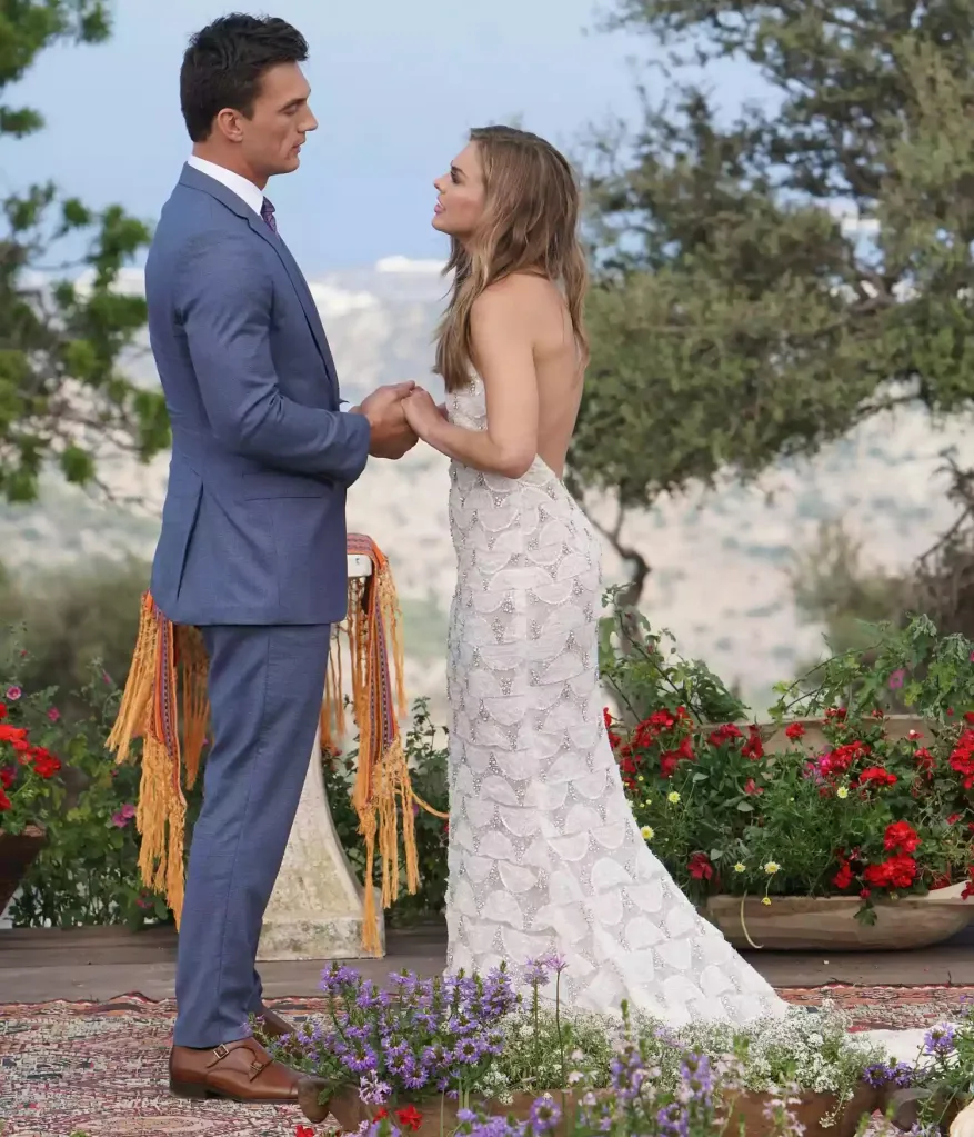 Tyler Cameron and Hannah Brown of The Bachelorette standing face to face, holding hands.