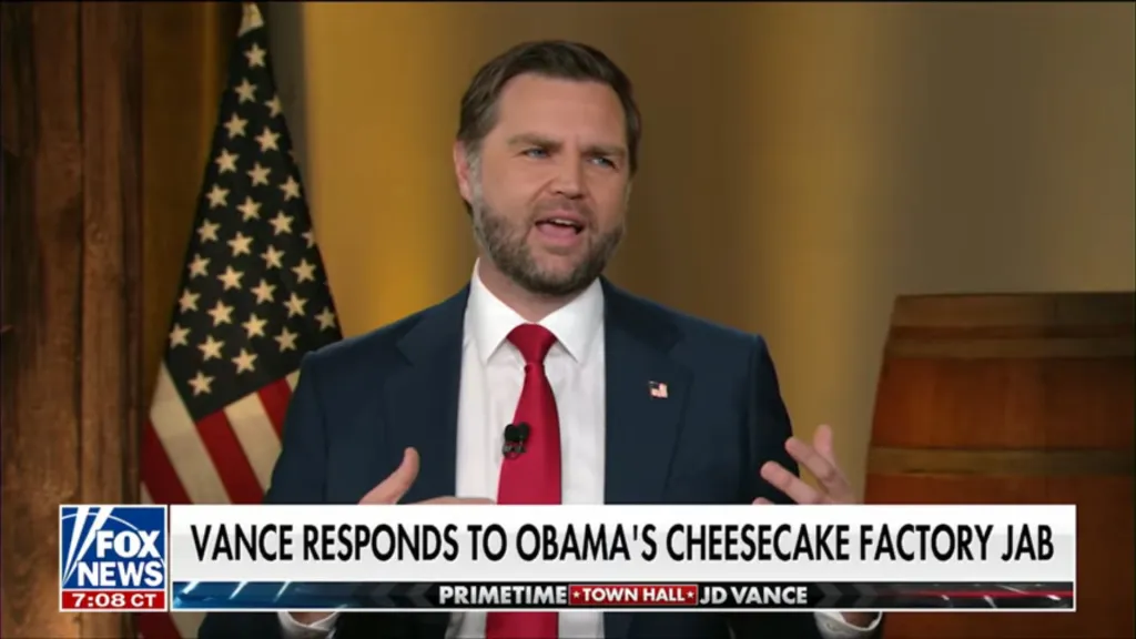 JD Vance speaking at a town hall, with a Fox News graphic at the bottom reading 