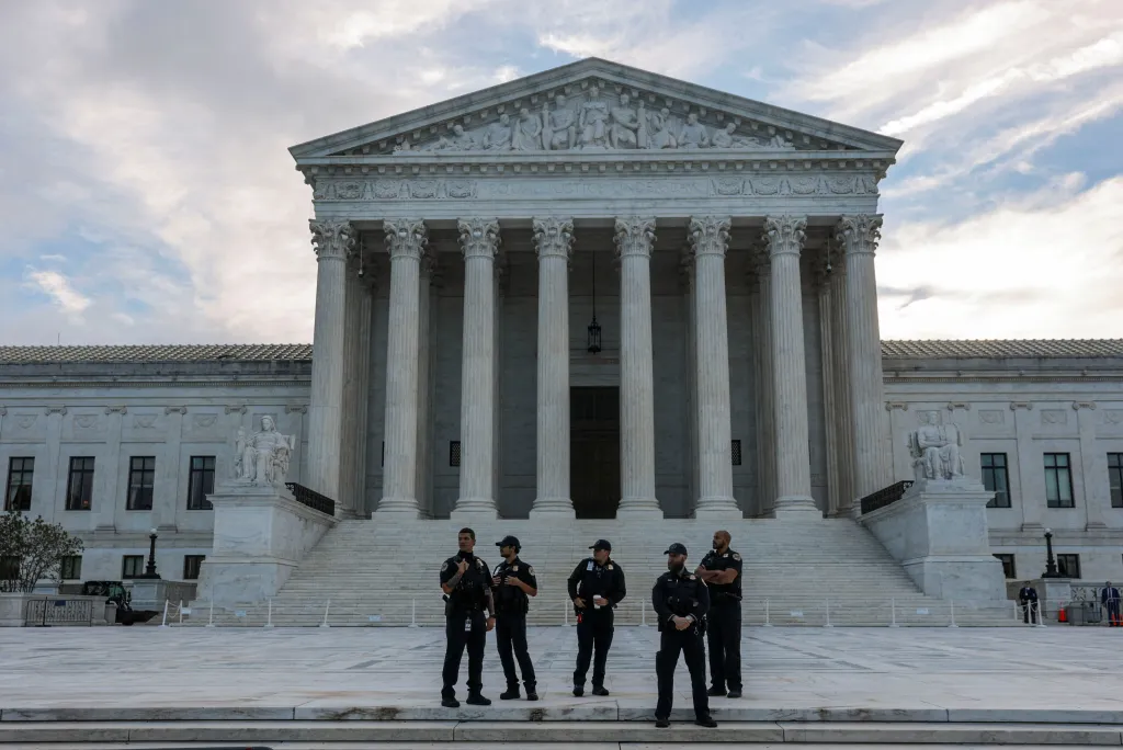 Supreme Court Police officers stand in front of the U.S. Supreme Court building.