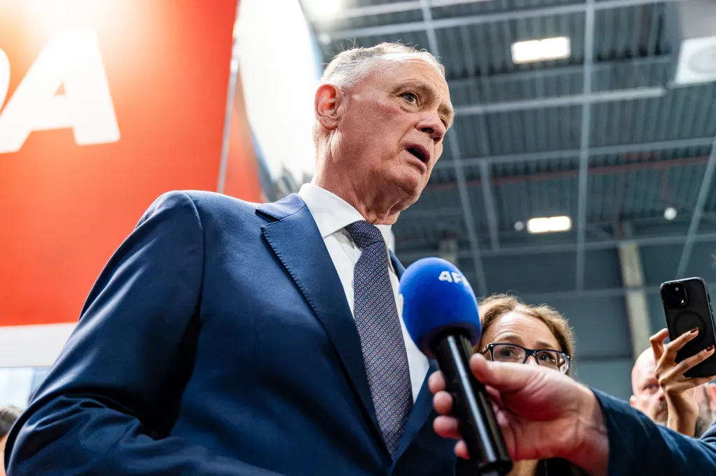 Canadian Minister of National Defence David McGuinty speaks into a microphone during an exhibition in Poland.