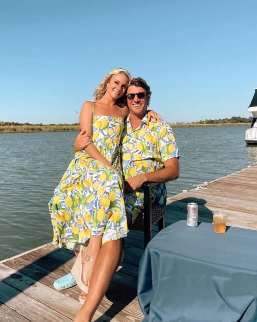 Taylor Ann Green and Shep Rose sitting on a dock together, wearing matching lemon-print outfits.