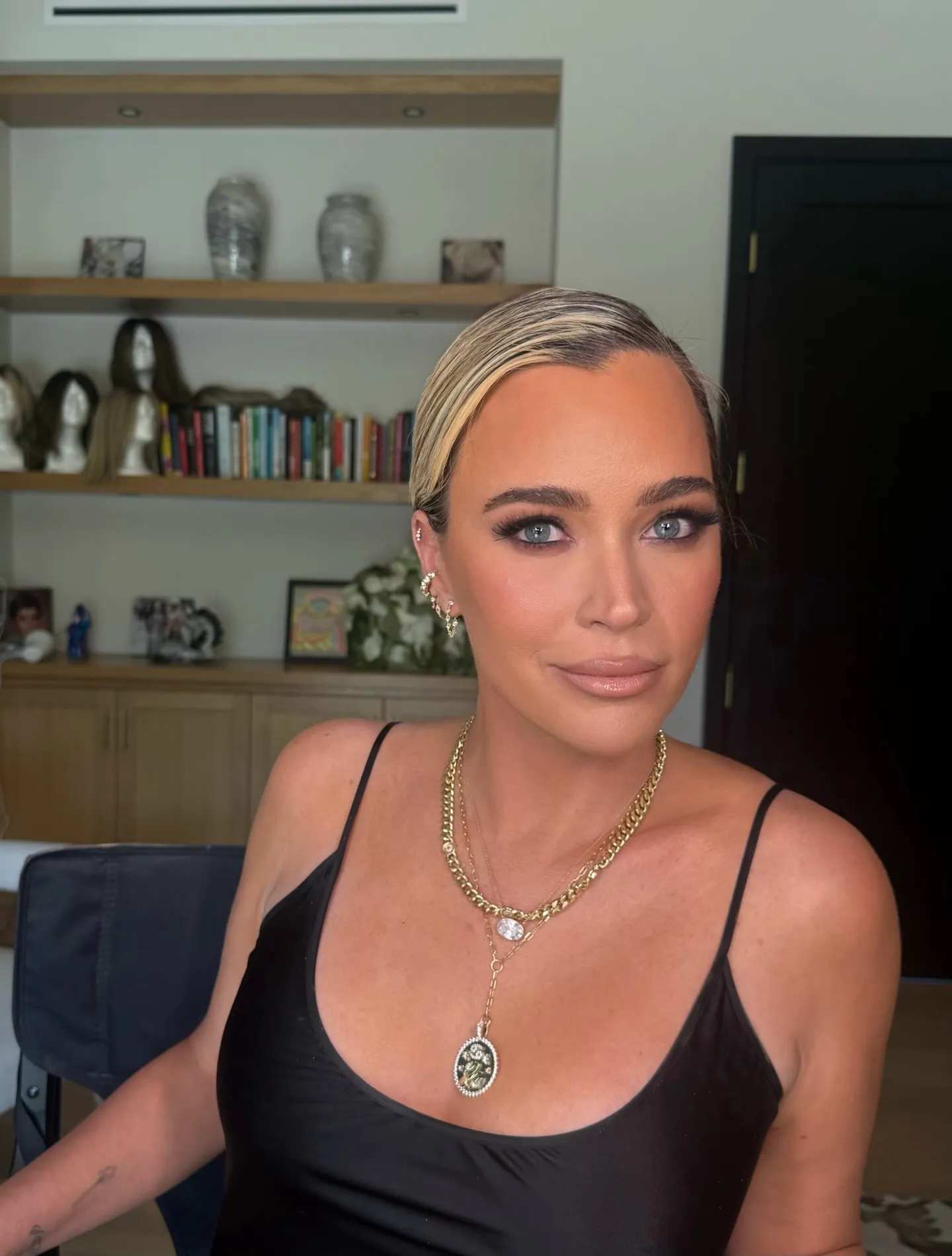 Teddi Mellencamp wearing a black top and gold jewelry.