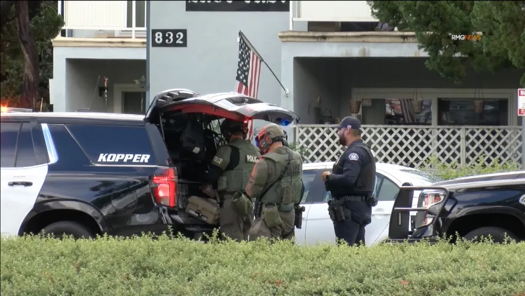 Police officers investigate the scene outside a residence in Arcadia, Los Angeles.
