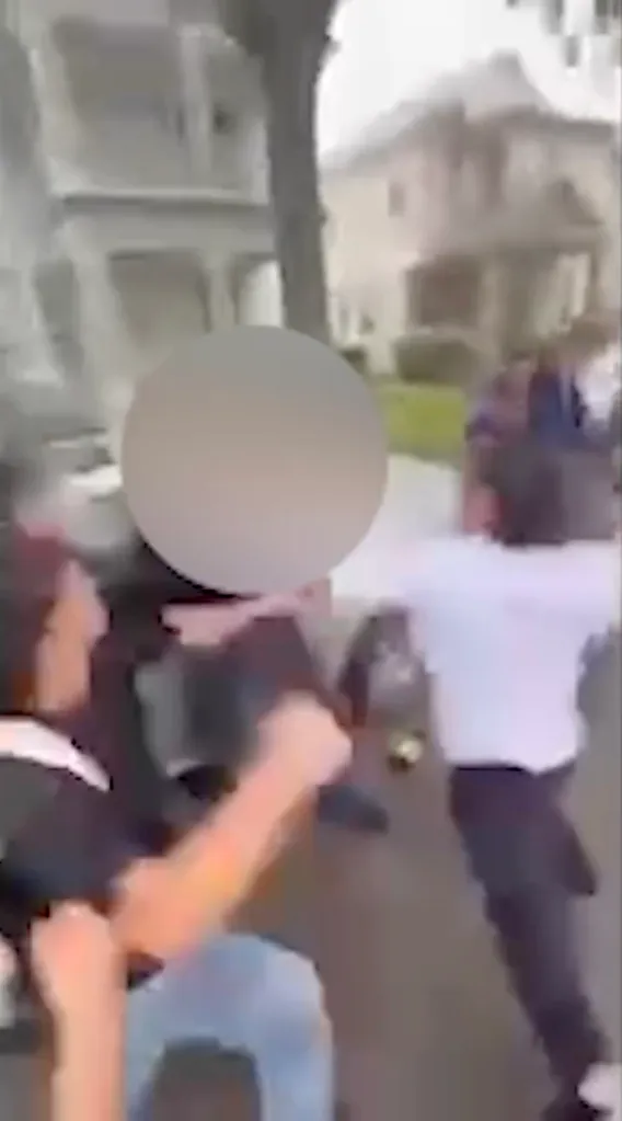A grainy, blurry image showing a group of teens involved in an alleged attack outside Harmony High School.