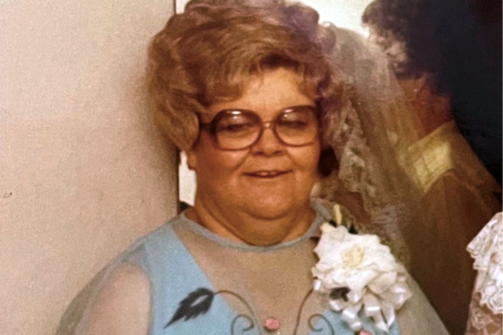 Photo of Betty Jo Norris wearing glasses and a corsage.