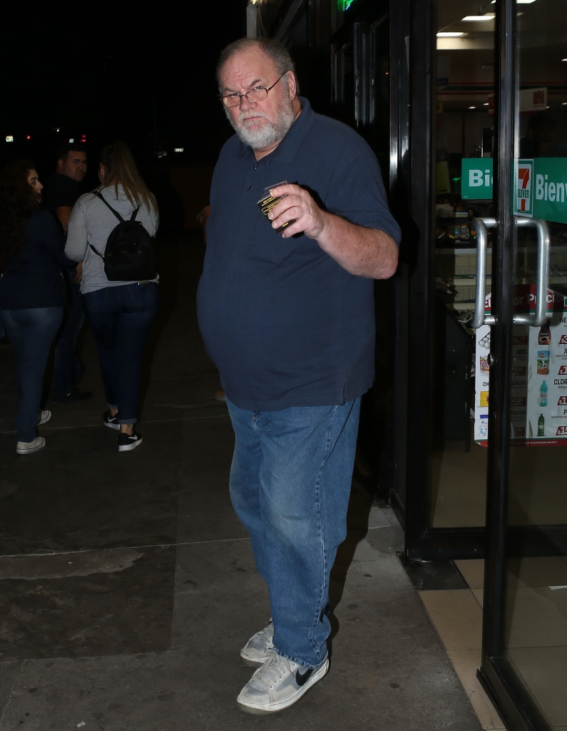 Thomas Markle outside a store at night, holding a cigarette pack.