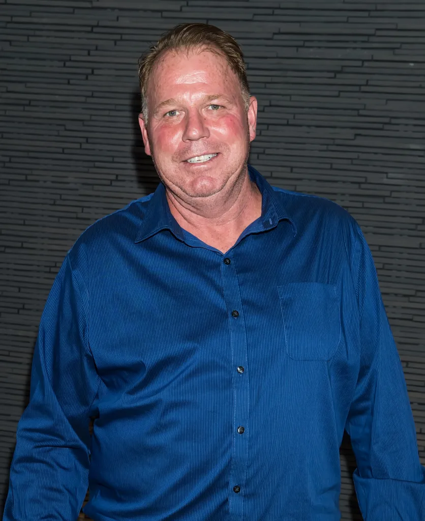 Thomas Markle Jr. wearing a blue button-down shirt.