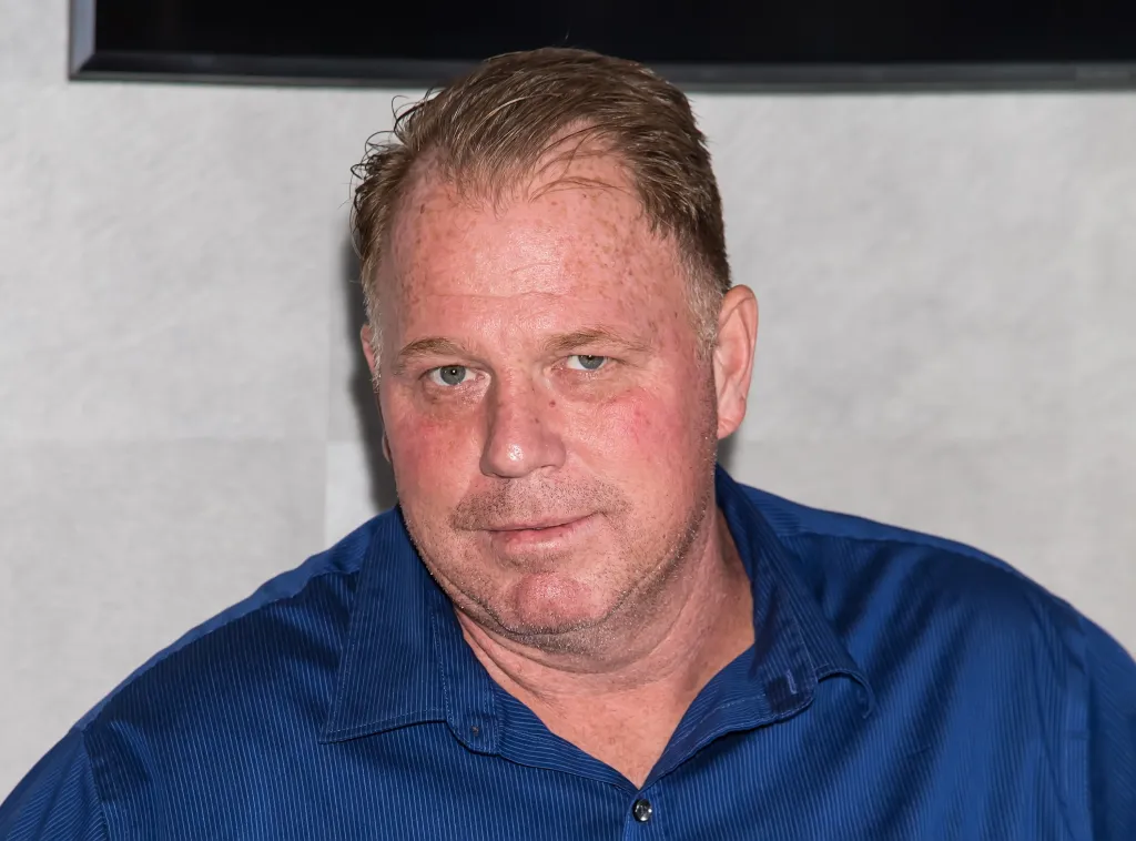 Thomas Markle Jr. wearing a blue button-down shirt.
