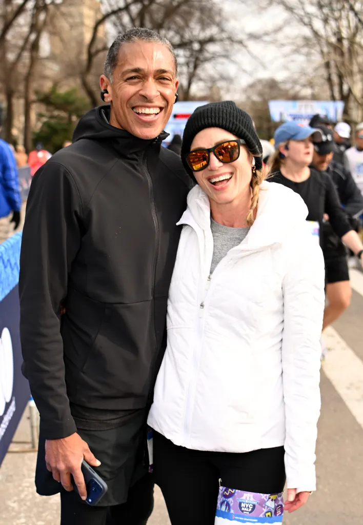TJ Holmes and Amy Robach pose together after crossing the finish line of the NYC Half Marathon.