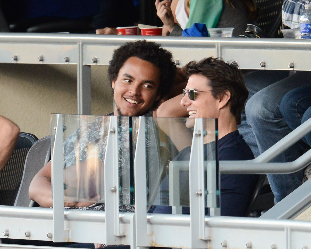 Tom Cruise and Connor Cruise sitting together at a baseball game.