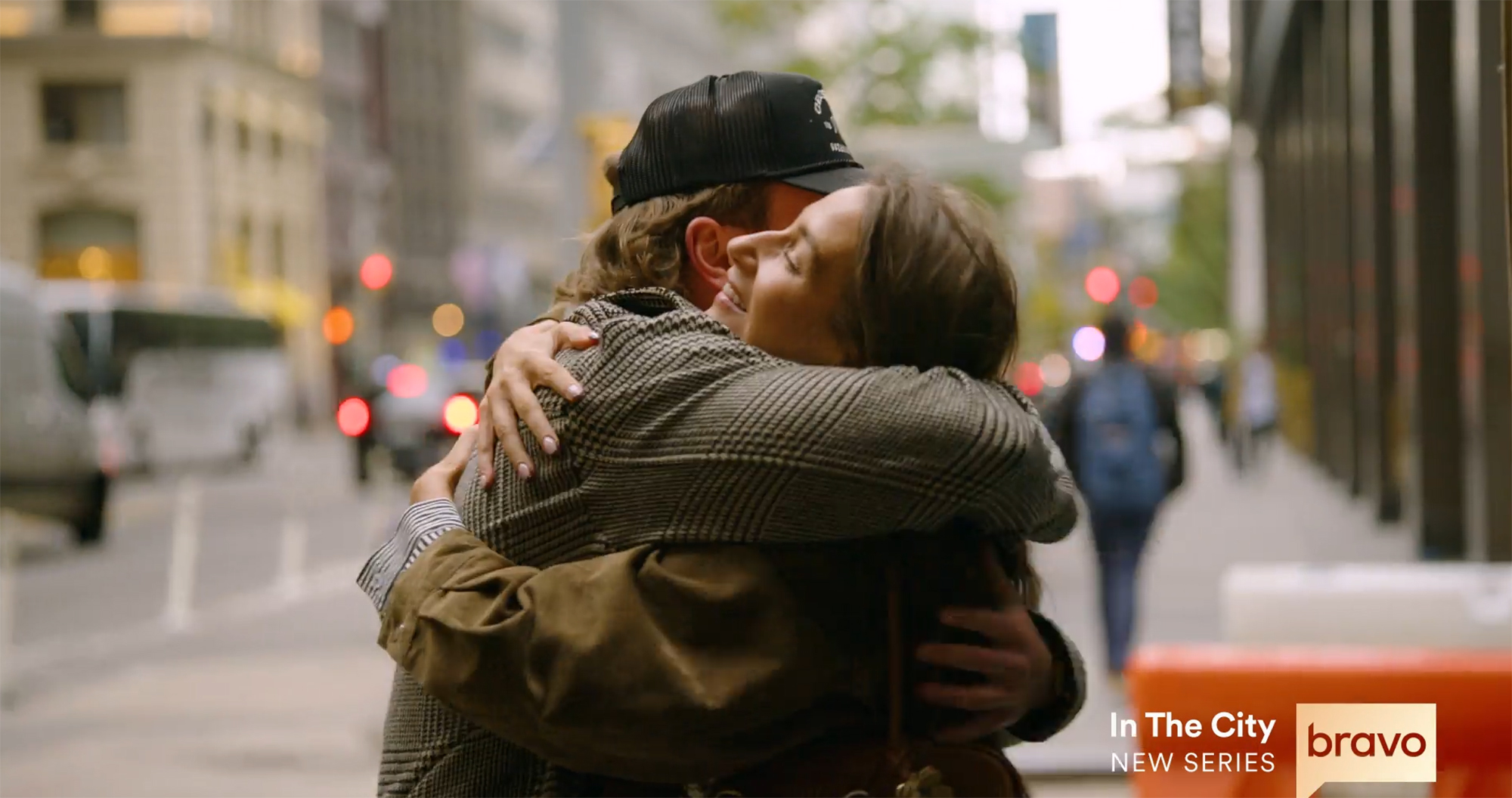 West Wilson and Amanda Batula hugging on a city street.